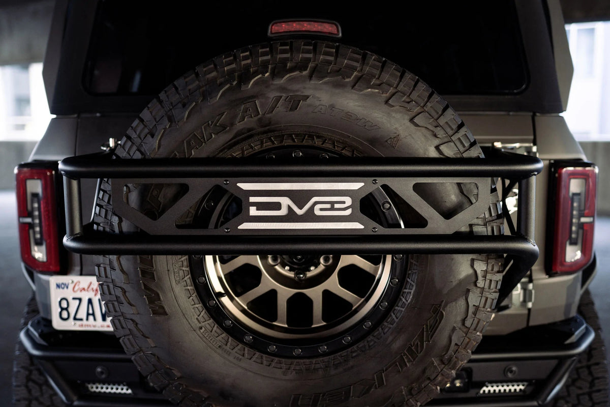 DV8 - DV8 Offroad 21 - 23 Ford Bronco Spare Tire Guard & Accessory Mount - Panda Motorworks